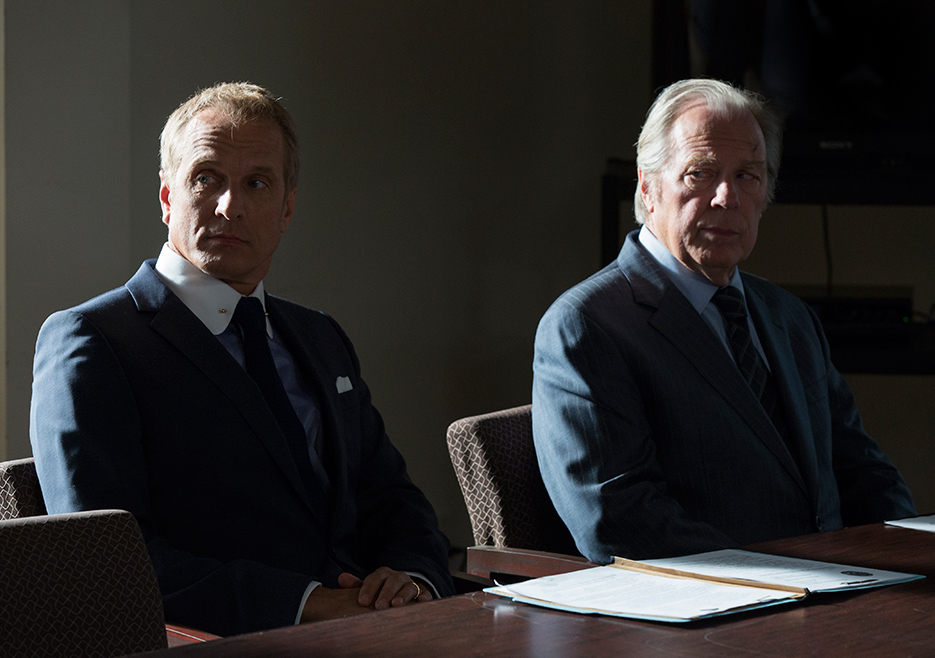 Howard Hamlin (Patrick Fabian) and Chuck McGill (Michael McKean) sitting at a conference table, looking aside at someone off camera.
