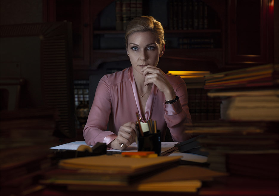 Kim Wexler (Rhea Seehorn) sitting at her desk and pondering